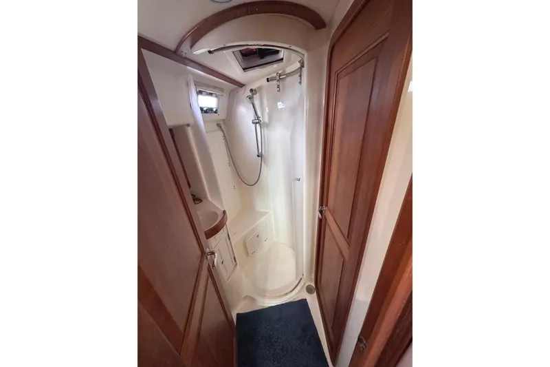 Slide: The Image of 2016 Tartan 4000 yacht bathroom with shower, wooden cabinetry, and compact design. - 33