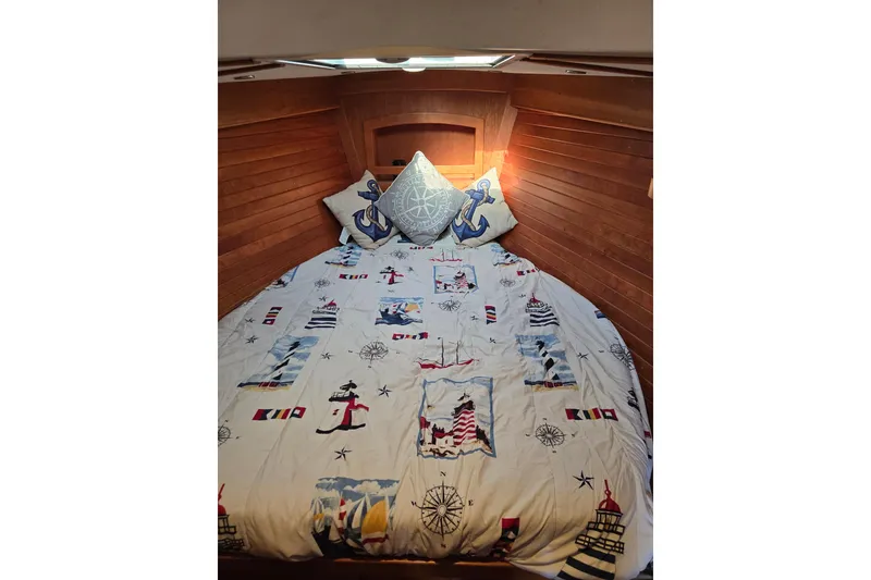 Slide: The Image of Cozy nautical-themed bed in 2016 Tartan 4000 sailboat cabin. - 34