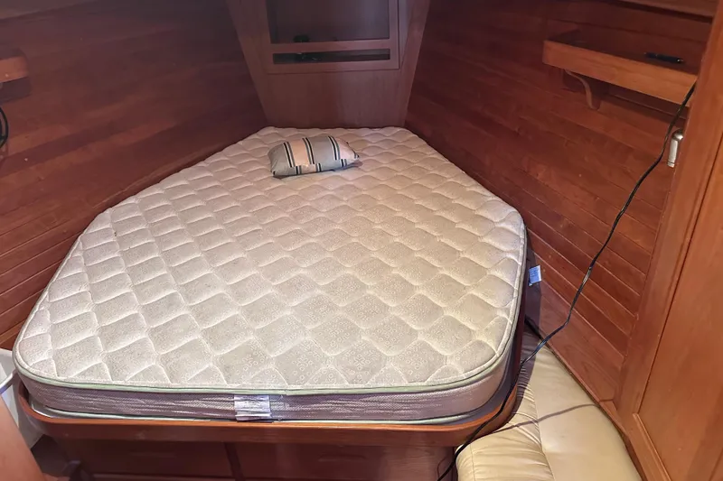 Slide: The Image of Cozy cabin bed in 2016 Tartan 4000 yacht with wooden interior and striped pillow. - 35
