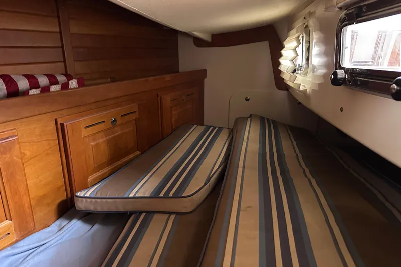 Slide: The Image of Cozy cabin interior of 2016 Tartan 4000 sailboat with striped cushions and wooden cabinetry. - 36