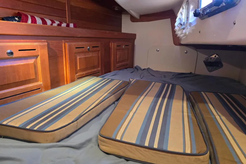 Slide: The Image of Cozy cabin interior of 2016 Tartan 4000 sailboat with striped cushions and wooden cabinetry. - 37