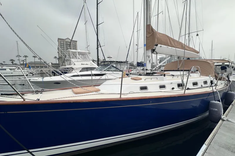 Slide: The Image of Sailboat docked in marina, Tartan 4000 model, 2016, with blue hull and tan covers. - 4