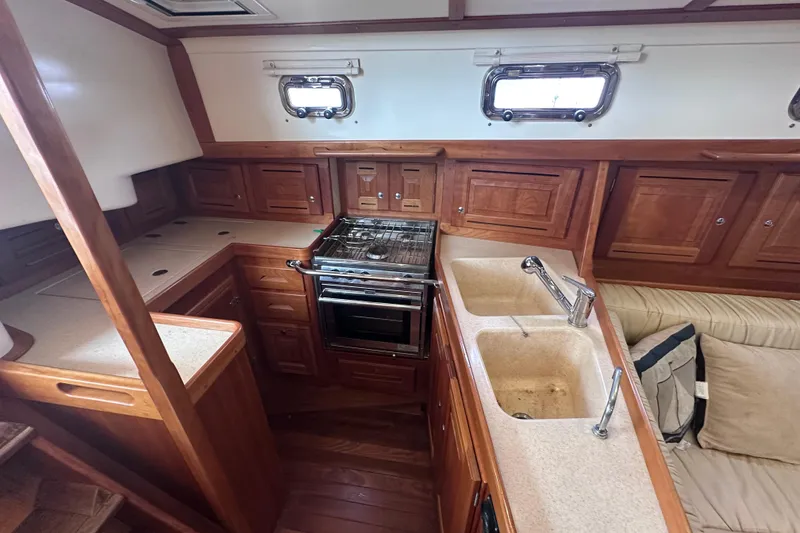 Slide: The Image of Interior of 2016 Tartan 4000 yacht kitchen with wooden cabinetry and dual sinks. - 40