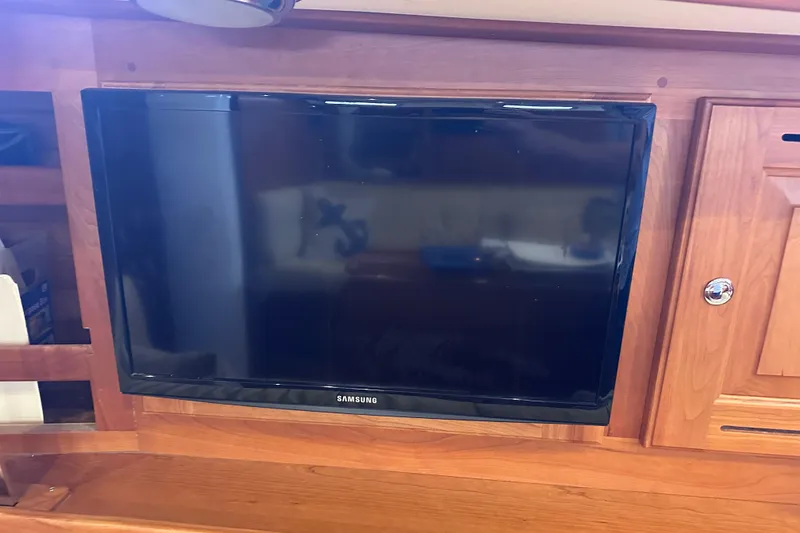 Slide: The Image of Samsung TV mounted on wooden cabinetry inside a 2016 Tartan 4000 yacht. - 42
