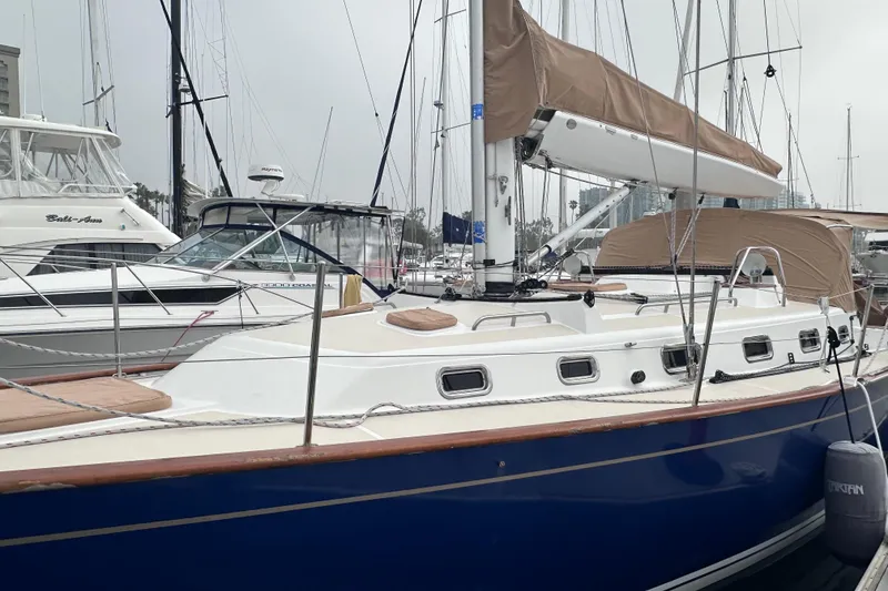 Slide: The Image of Sailboat Tartan 4000, 2016 model, docked in a marina with beige sail cover. - 5
