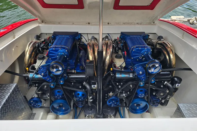 Slide: The Image of Twin blue engines in a 2004 Hustler 388 SLINGSHOT boat. - 10