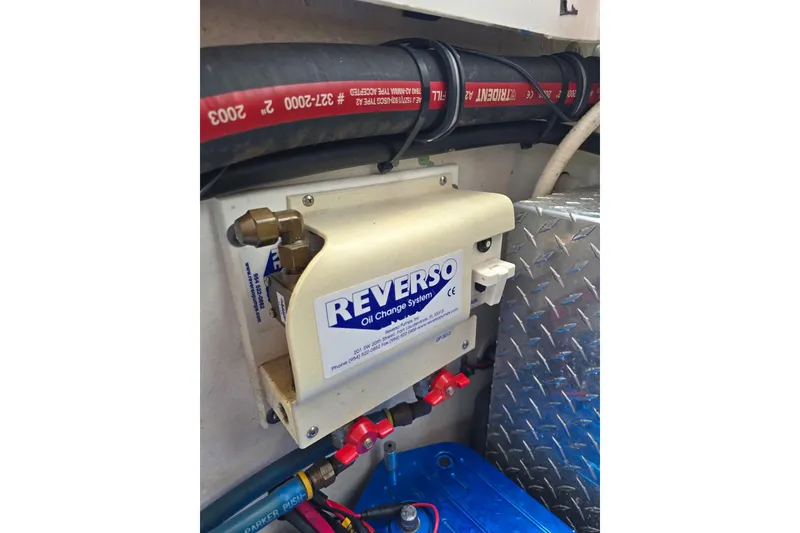 Slide: The Image of Reverso oil change system in 2004 Hustler 388 SLINGSHOT boat engine compartment. - 12