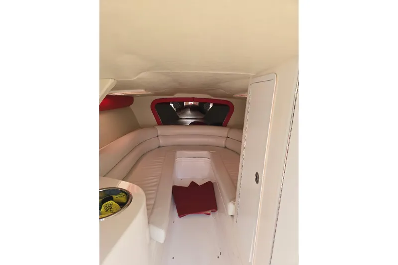 Slide: The Image of Interior of a 2004 Hustler 388 SLINGSHOT boat with white and red seating. - 8