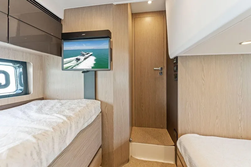 Slide: The Image of Interior of 2021 Azimut Atlantis 45 yacht cabin with TV and twin beds. - 36