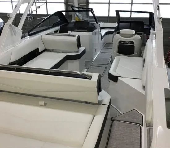Slide: The Image of Interior view of 2025 Cobalt R6 Surf boat with luxurious white seating. - 4