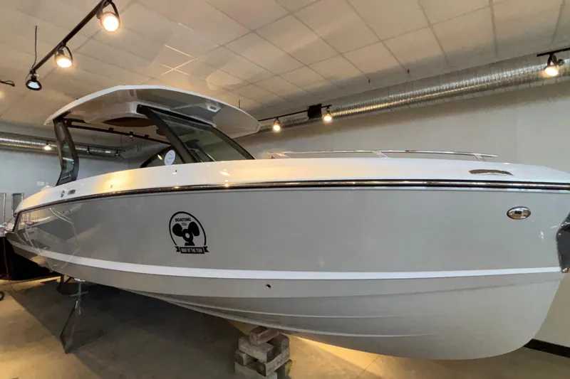 The Image of 2026 Monterey Elite 30 OB boat displayed indoors with modern lighting. - 1