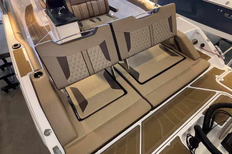 Slide: The Image of Luxury seating on 2026 Monterey Elite 30 OB boat, featuring elegant tan upholstery. - 13