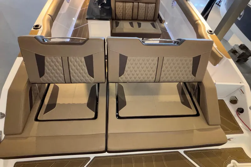 Slide: The Image of 2026 Monterey Elite 30 OB boat interior with luxurious tan seating and modern design. - 14