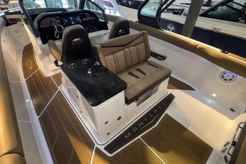 Slide: The Image of 2026 Monterey Elite 30 OB boat interior with luxurious seating and modern dashboard. - 18