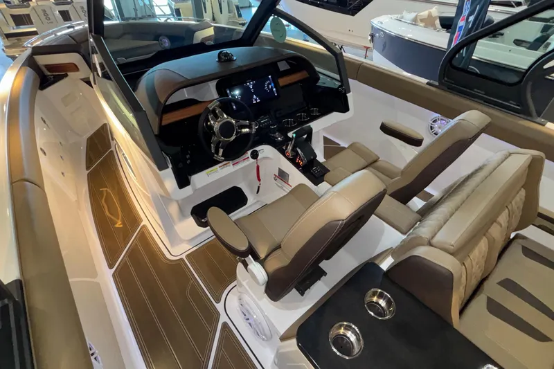 Slide: The Image of Interior view of 2026 Monterey Elite 30 OB boat, featuring luxurious seating and modern dashboard. - 19