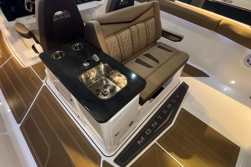 Slide: The Image of Luxurious interior of 2026 Monterey Elite 30 OB boat with seating and sink. - 22