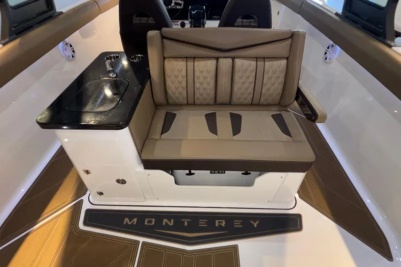 Slide: The Image of 2026 Monterey Elite 30 OB boat interior with cushioned seating and sleek design. - 23