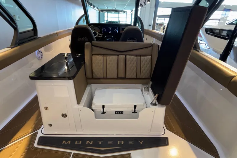 Slide: The Image of Interior of 2026 Monterey Elite 30 OB boat with seating and storage area. - 26
