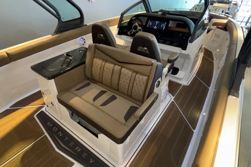 Slide: The Image of Luxurious interior of 2026 Monterey Elite 30 OB boat with plush seating and modern dashboard. - 27