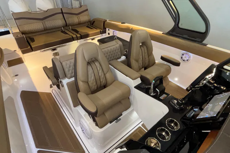 Slide: The Image of Luxurious interior of 2026 Monterey Elite 30 OB boat with plush seating and modern controls. - 31