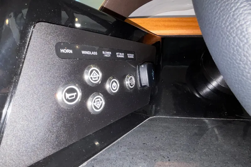 Slide: The Image of Control panel of 2026 Monterey Elite 30 OB boat with labeled buttons and switches. - 35