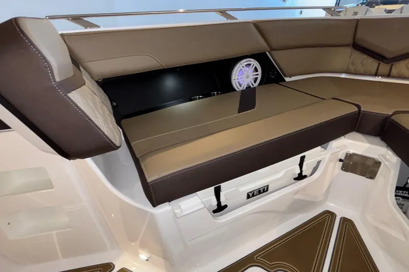 Slide: The Image of Luxurious seating area on 2026 Monterey Elite 30 OB boat with YETI cooler storage. - 44