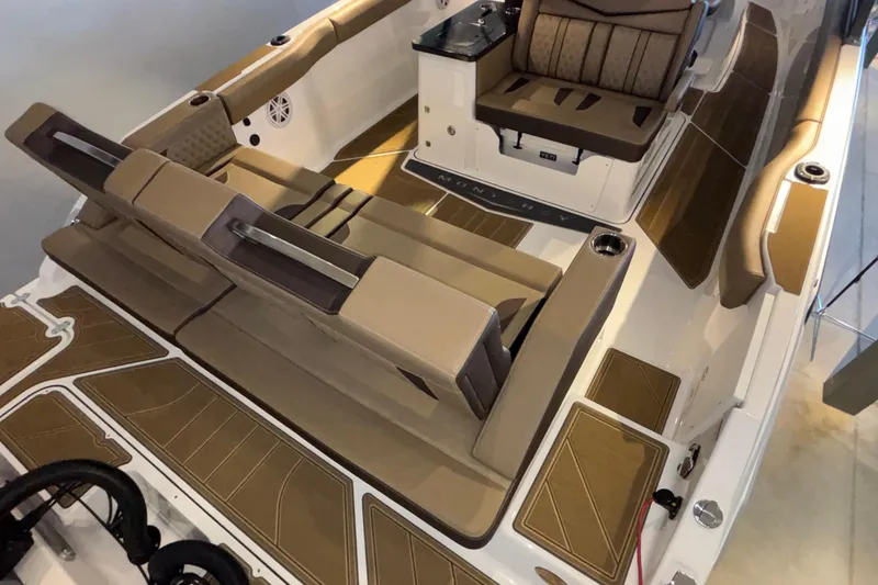 Slide: The Image of 2026 Monterey Elite 30 OB boat interior with tan seating and modern design. - 5