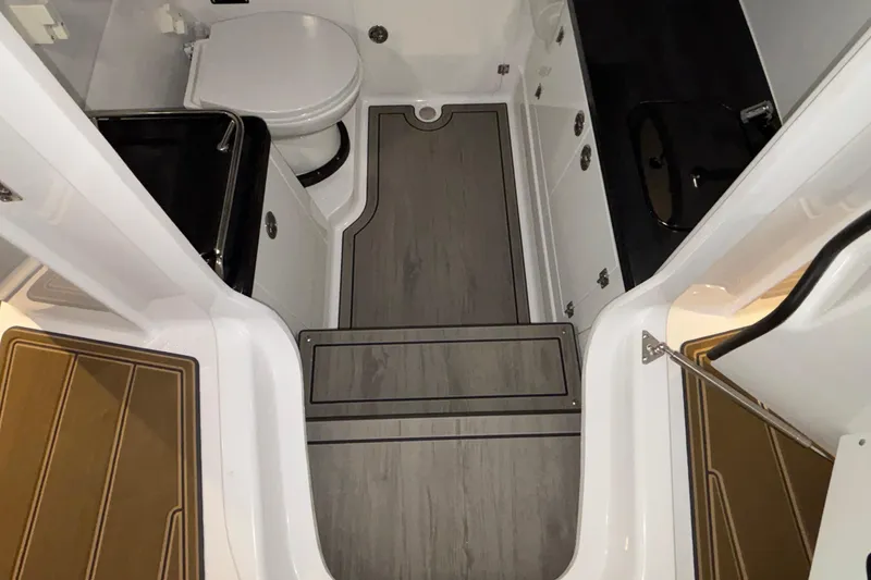 Slide: The Image of 2026 Monterey Elite 30 OB boat interior with modern bathroom and sleek flooring design. - 52