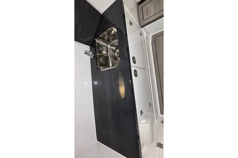 Slide: The Image of 2026 Monterey Elite 30 OB boat interior with sleek sink and storage cabinets. - 56
