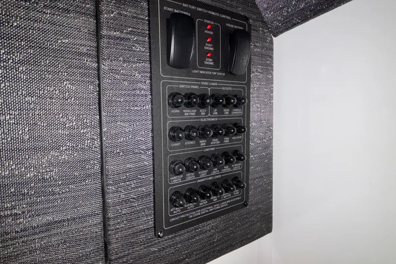 Slide: The Image of Control panel of 2026 Monterey Elite 30 OB boat with switches and indicators. - 62