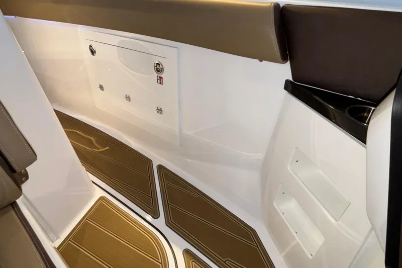 Slide: The Image of Interior view of 2026 Monterey Elite 30 OB boat, featuring sleek seating and storage compartments. - 64