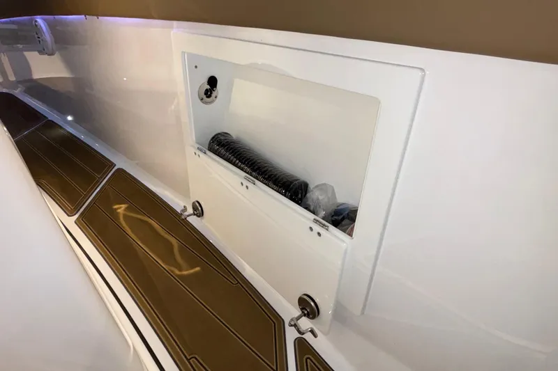 Slide: The Image of Storage compartment on 2026 Monterey Elite 30 OB boat interior. - 65