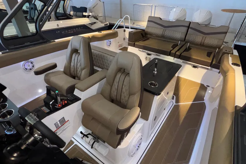 Slide: The Image of Luxurious interior of 2026 Monterey Elite 30 OB boat with plush seating and modern controls. - 68