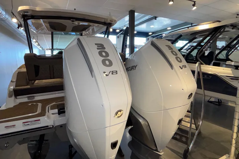 Slide: The Image of 2026 Monterey Elite 30 OB with dual Mercury 300 V8 engines in showroom. - 77