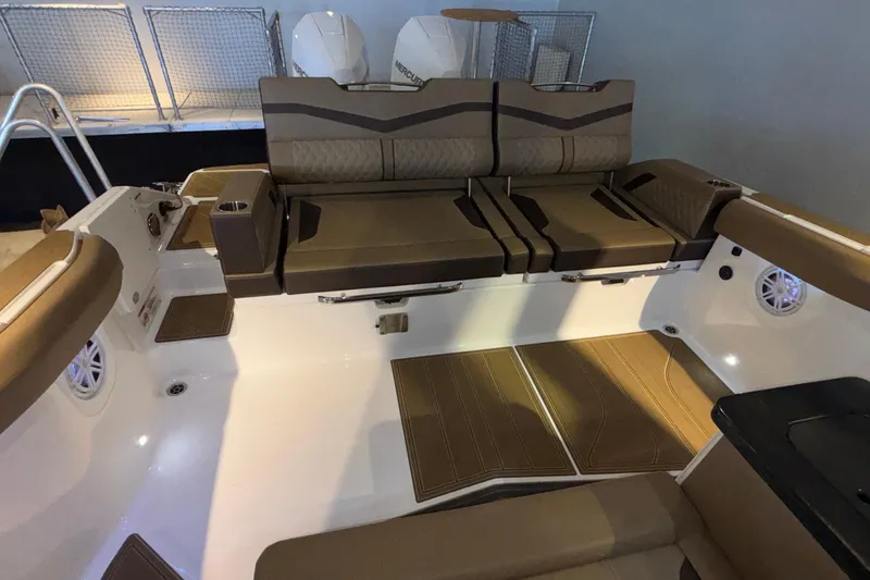 Slide: The Image of 2026 Monterey Elite 30 OB boat interior with brown seating and modern design. - 8