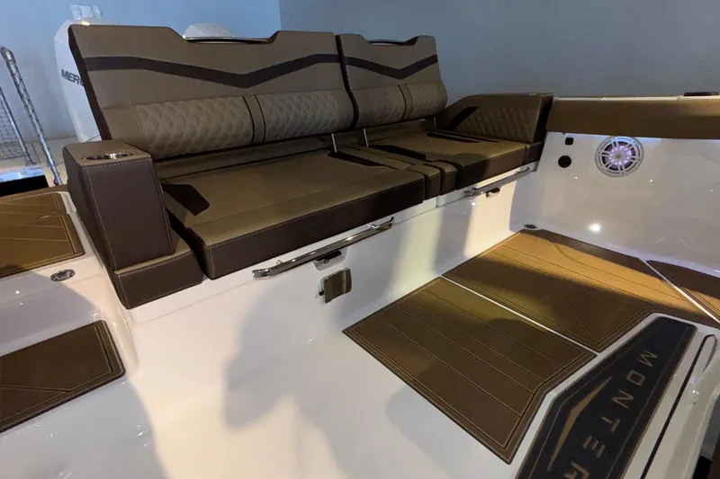 Slide: The Image of Luxurious seating on 2026 Monterey Elite 30 OB boat, featuring brown upholstery and sleek design. - 9