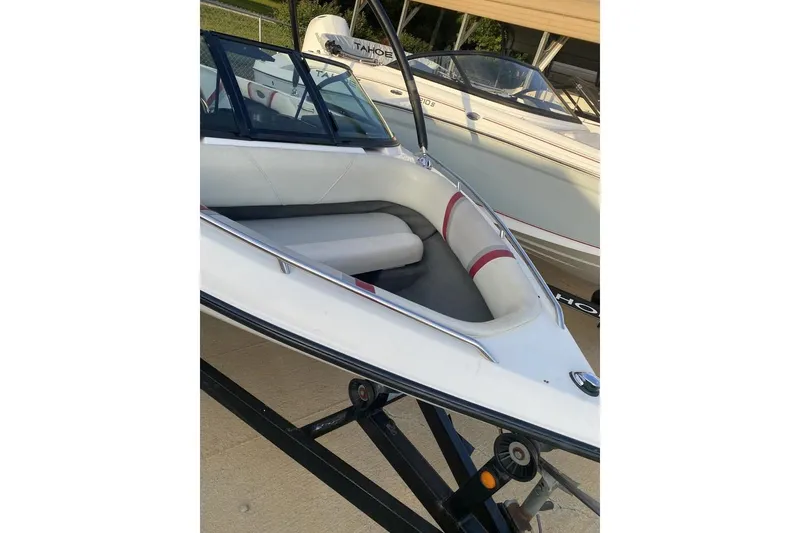 Slide: The Image of 2002 Malibu Response LX boat on trailer, featuring white and red interior. - 5