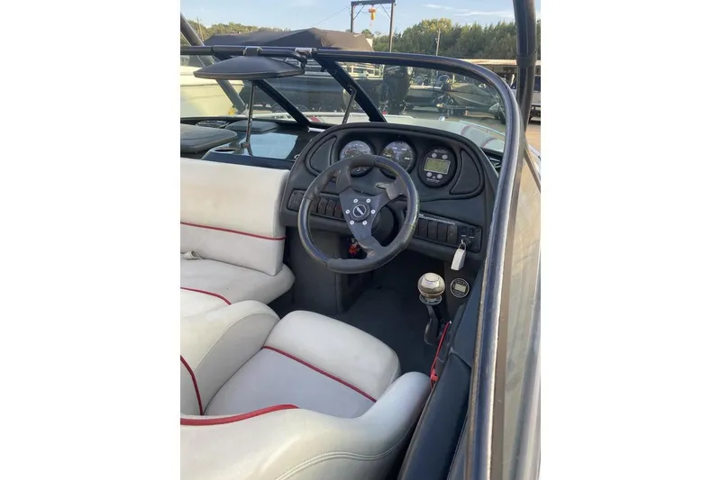 Slide: The Image of 2002 Malibu Response LX boat interior with steering wheel and dashboard controls. - 8