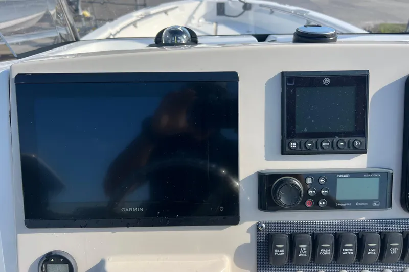 Slide: The Image of Control panel of a 2021 Boston Whaler 250 Dauntless with Garmin display and switches. - 11