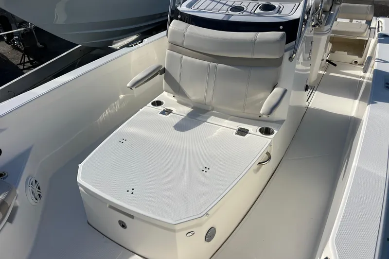 Slide: The Image of 2021 Boston Whaler 250 Dauntless boat interior with cushioned seating and console. - 15