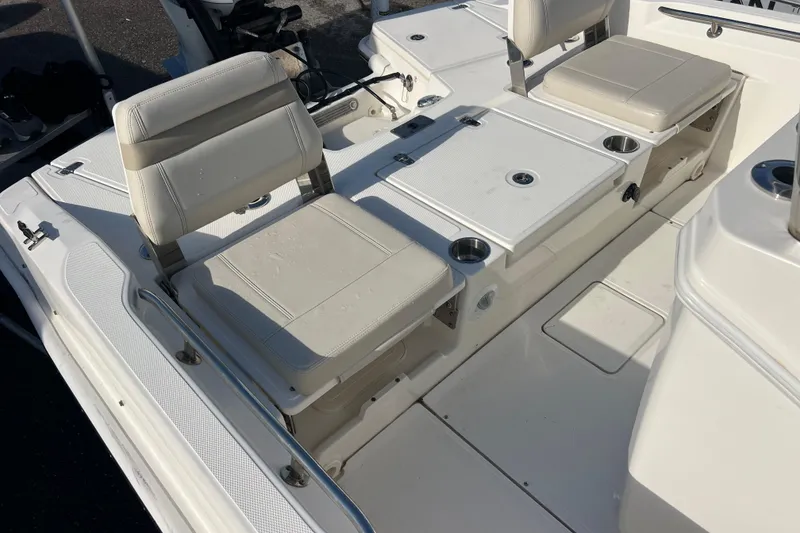 Slide: The Image of 2021 Boston Whaler 250 Dauntless boat interior with cushioned seating and storage compartments. - 18