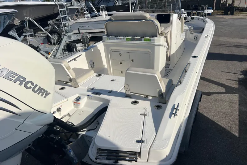 Slide: The Image of 2021 Boston Whaler 250 Dauntless boat with Mercury engine, docked in a marina. - 6