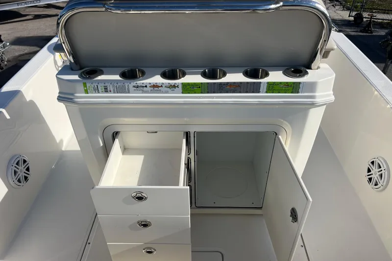 Slide: The Image of 2021 Boston Whaler 250 Dauntless boat interior with storage compartments and cup holders. - 8