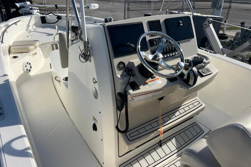 Slide: The Image of 2021 Boston Whaler 250 Dauntless boat cockpit with steering wheel and control panel. - 9