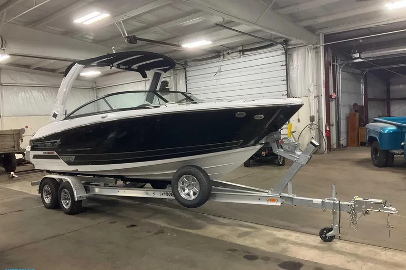 The Image of 2023 Monterey 238SS Super Sport boat on trailer in indoor garage. - 0