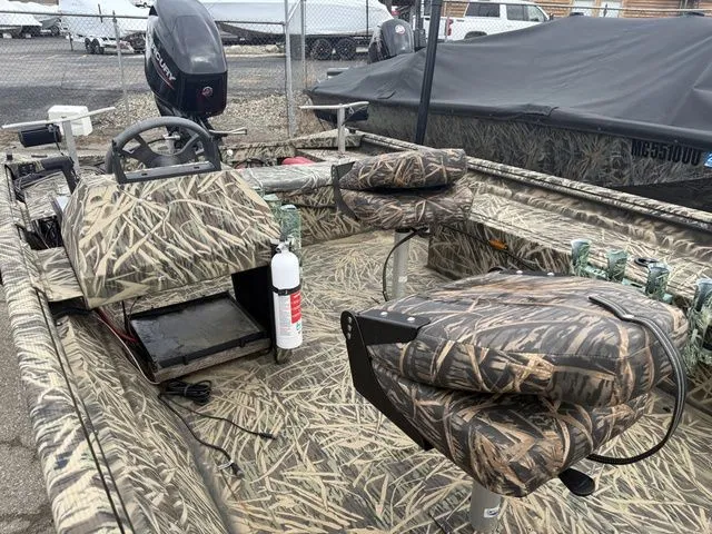 Slide: The Image of 2022 Lowe 1860 ROUGHNECK SC boat with camouflage pattern and steering console. - 5