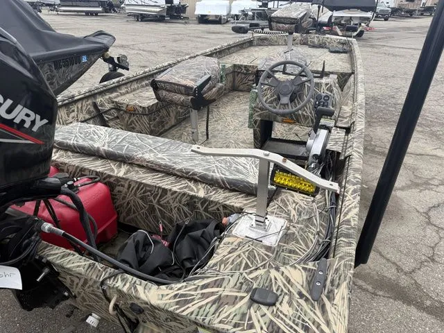 Slide: The Image of 2022 Lowe 1860 ROUGHNECK SC boat with camouflage design and outboard motor. - 7