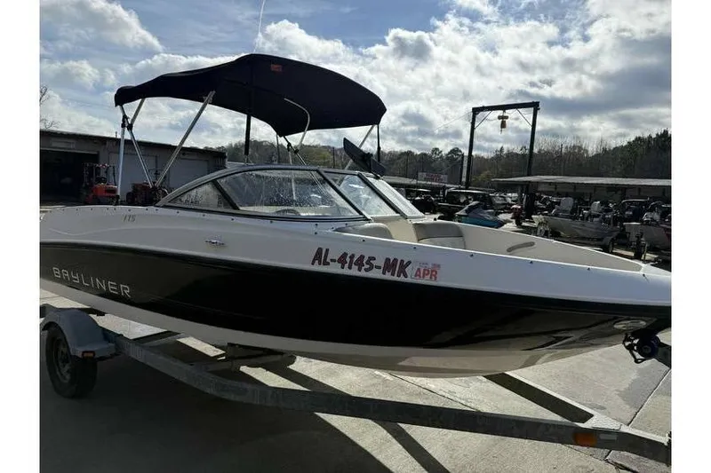 Slide: The Image of 2012 Bayliner 175 Bowrider boat on trailer under cloudy sky. - 1
