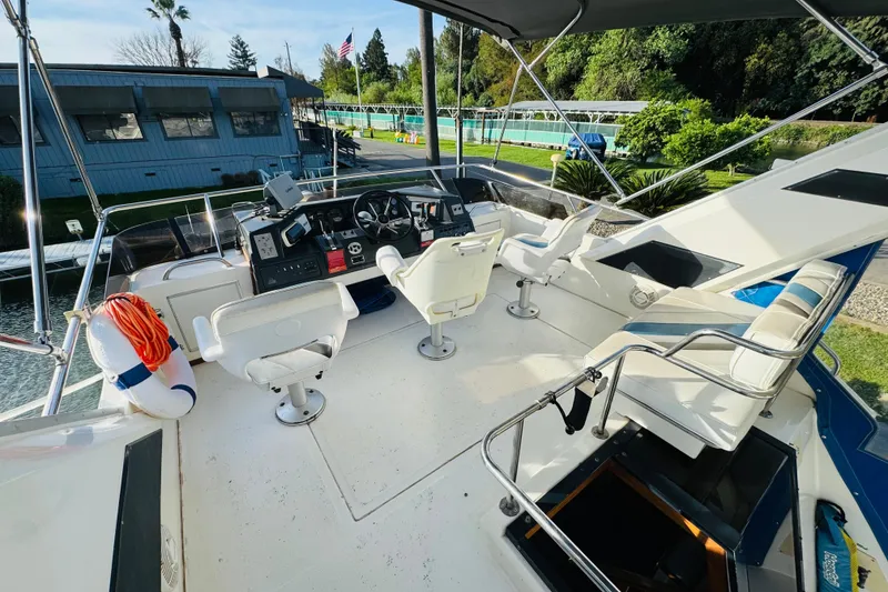 Slide: The Image of 1991 Sea Ray 380 Aft Cabin boat helm with seating and navigation equipment. - 12