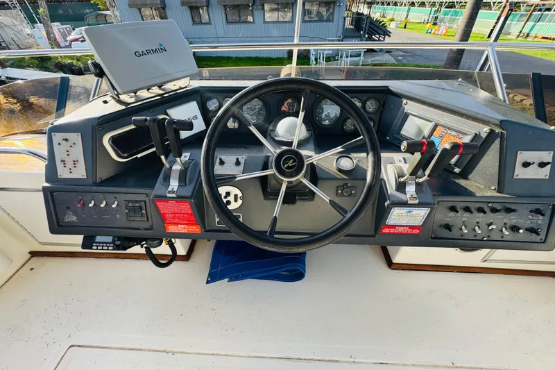 Slide: The Image of 1991 Sea Ray 380 Aft Cabin helm with Garmin navigation and control panel. - 14